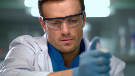 Scientist-using-pipette-in-laboratory.-Scientist-using-dropper